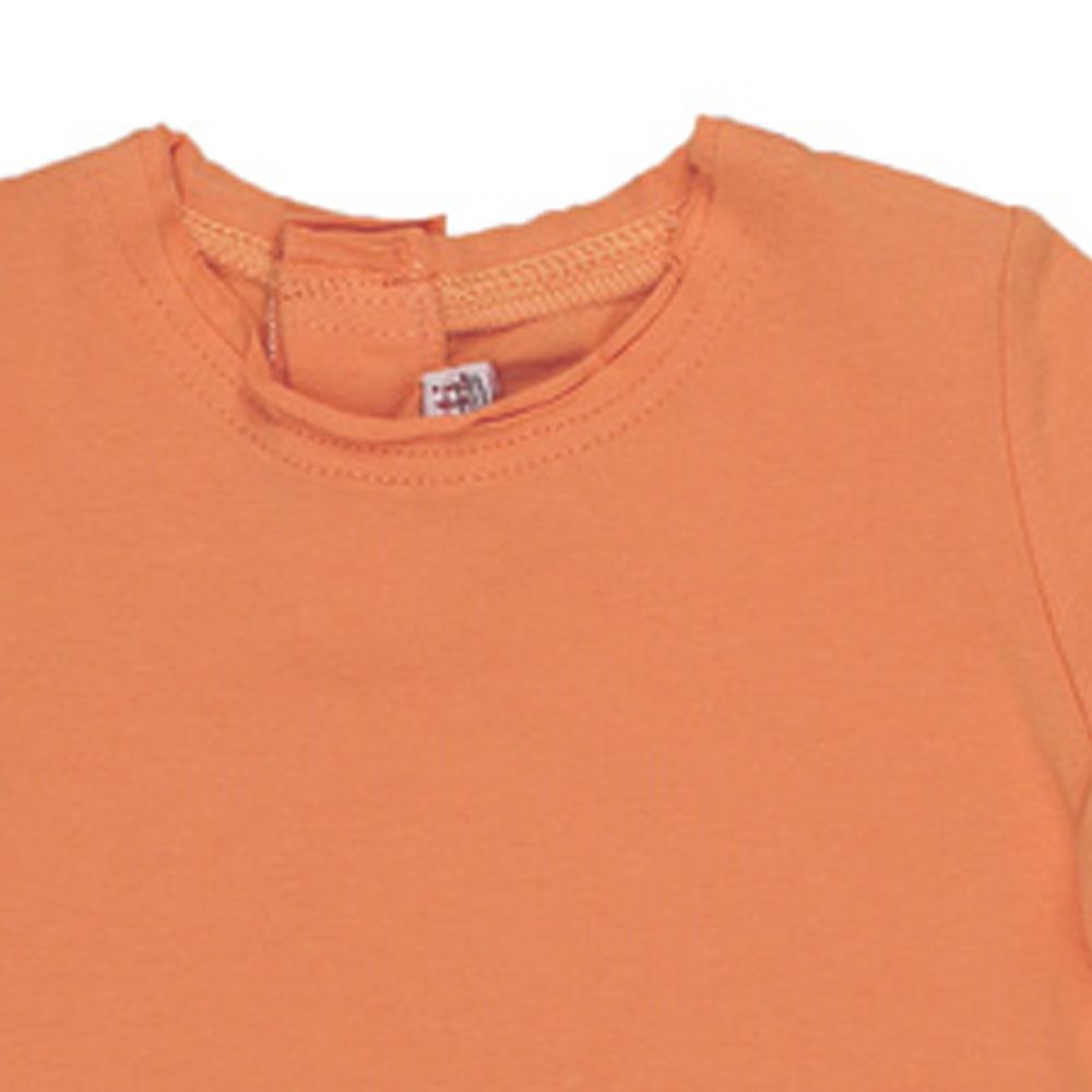 Confetti by Absorba. Orange baby bluse med rå kanter, udsnit